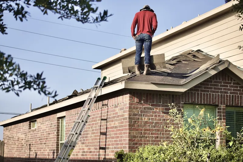 Professional roofer working on a residential roof in Sav-Mor